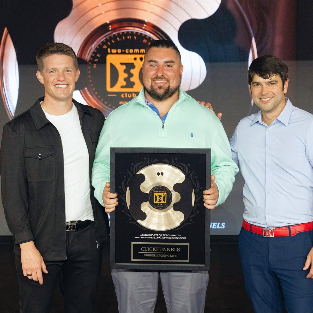 Eric Skeldon holding the Two Comma Club award for his first million in revenue with Kingdom Warriors in 2022